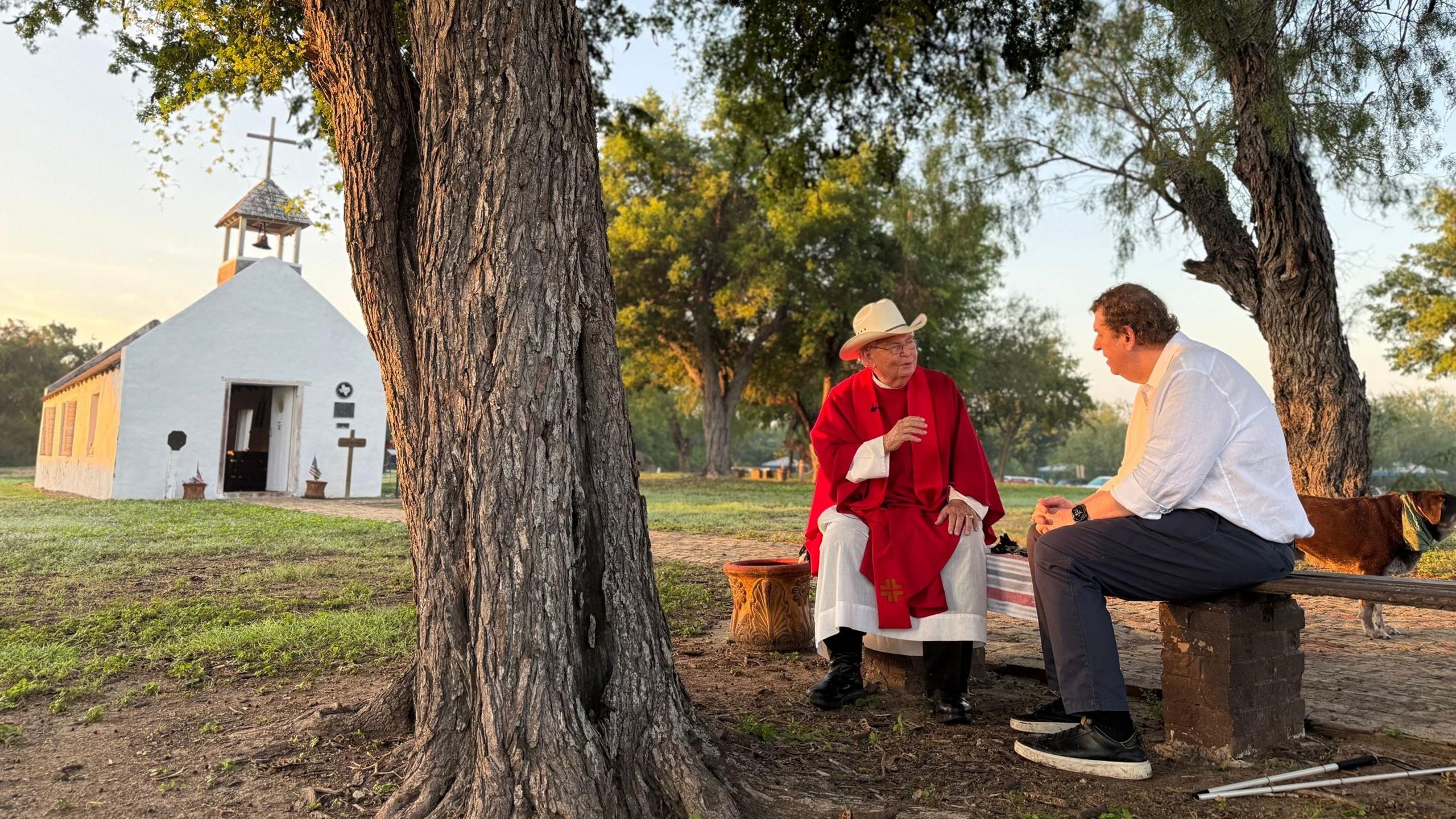 Father Roy Snipes standing outside La Lomita Catholic Chapel