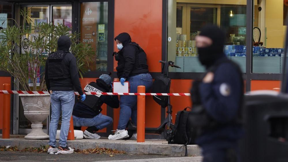 Police and emergency services at the scene of the shooting in Trappes