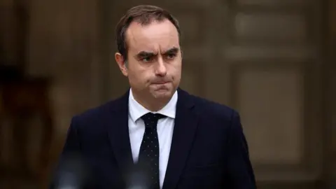 French PM Secures Key Budget Vote Amidst Political Tensions