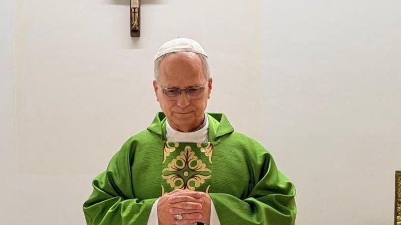 Pope in green robe celebrating Mass in hospital