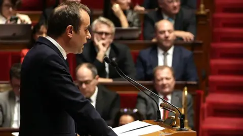 French Prime Minister Proposes Suspension of Macron's Pension Reforms Amid Government Turmoil